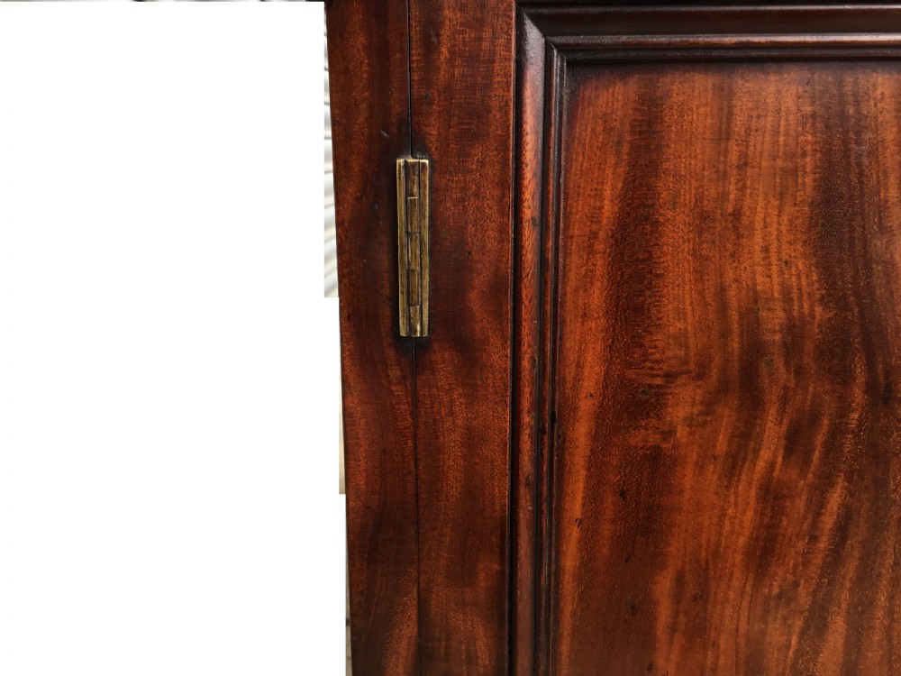 A Regency flame mahogany pedestal desk with an inset brown leather top, multiple drawers with turned wooden knobs, and twin panelled pedestals. View XII