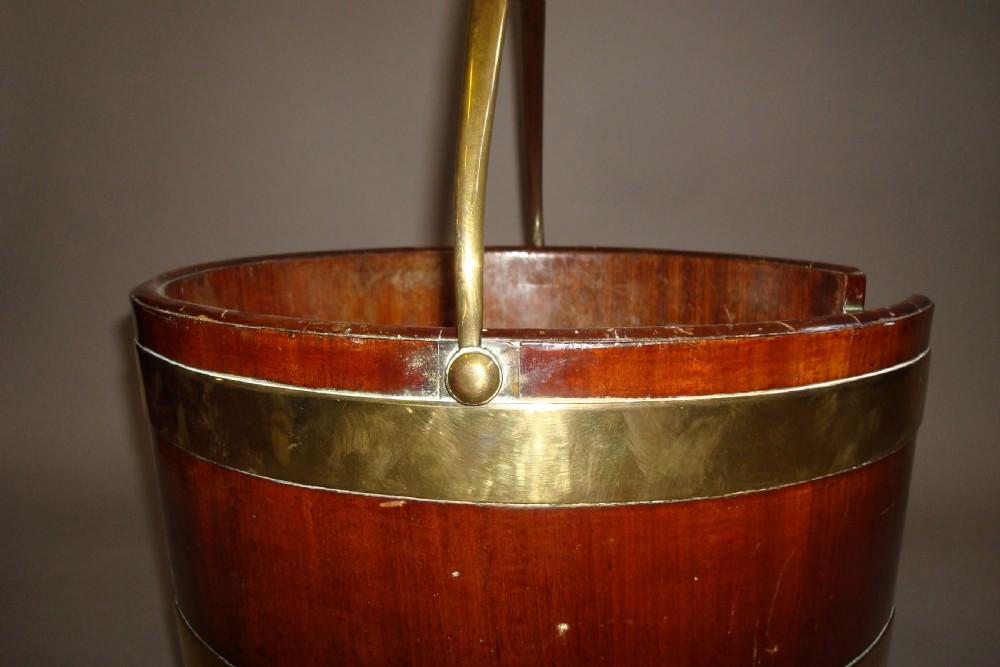 A pair of 18th-century mahogany plate buckets featuring brass binding straps, swing handles, and a vertical front cutout. View III