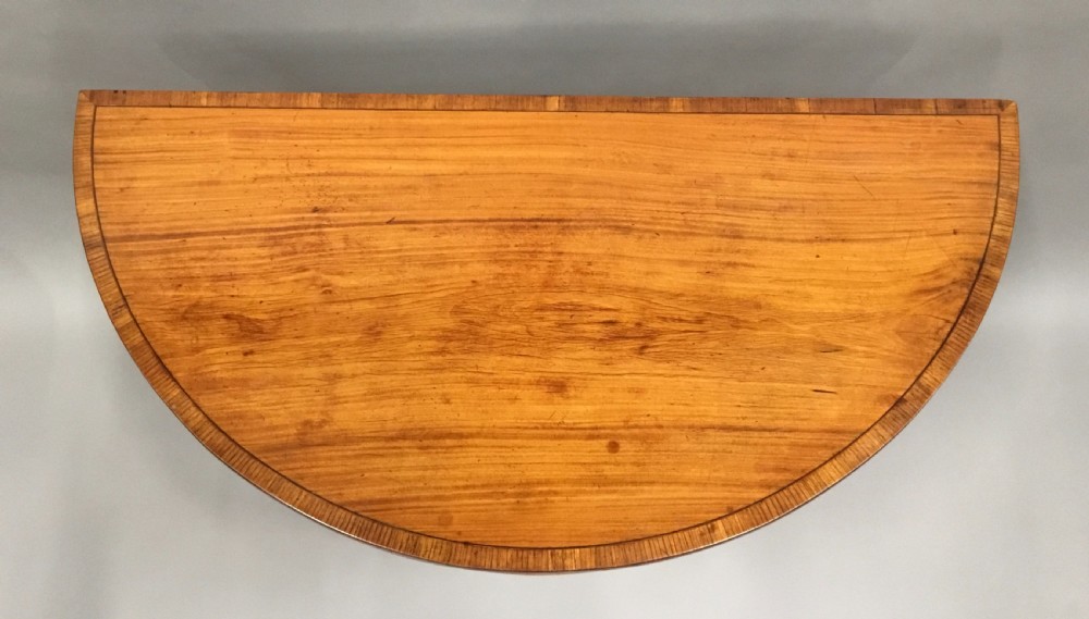 George III Satinwood demilune card table; in the Sheraton manner with an excellent colour View VI