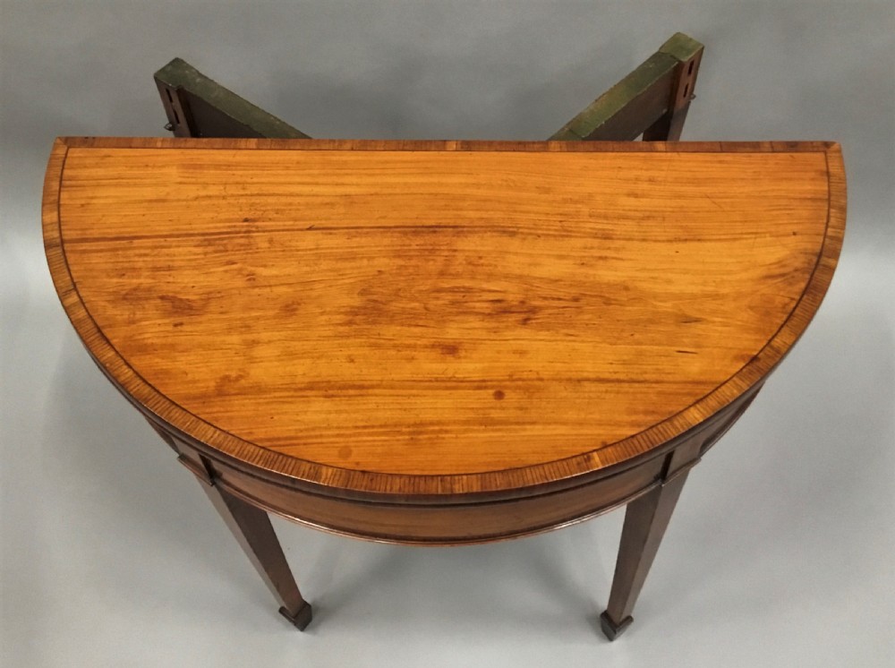 George III Satinwood demilune card table; in the Sheraton manner with an excellent colour View XIV