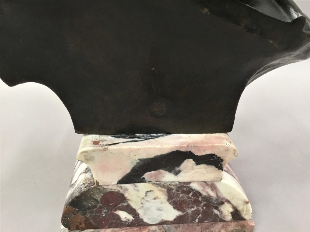 A 19th-century dark bronze bust depicting a helmeted Roman gladiator with a beard, mounted on a square variegated pink marble base. View XXI