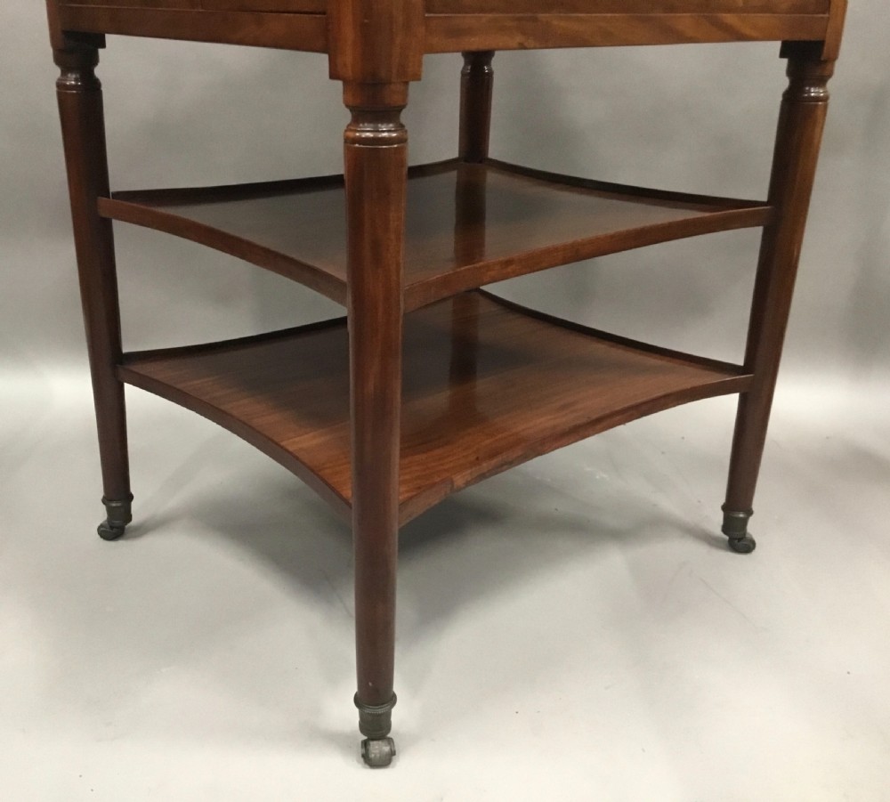 A French Louis XVI style mahogany rafraichissoir wine table with two inset metal bottle coolers, lower tiered shelves, and turned fluted legs on castors. View VI