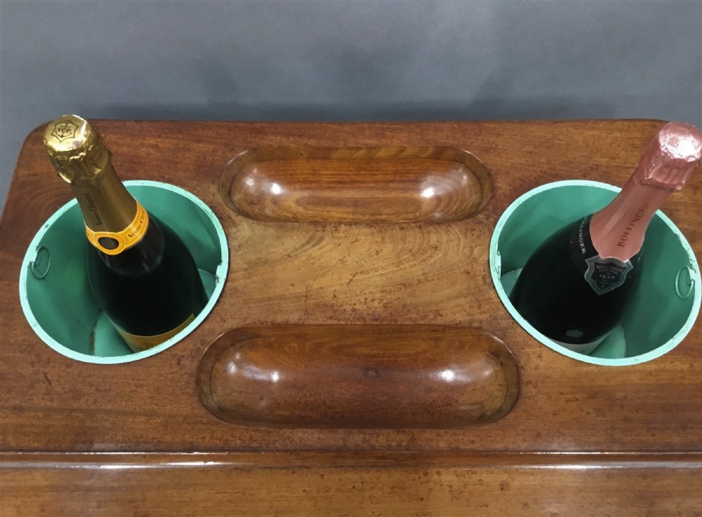 A French Louis XVI style mahogany rafraichissoir wine table with two inset metal bottle coolers, lower tiered shelves, and turned fluted legs on castors. View VIII