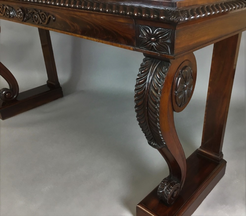 A Regency period dark mahogany serving table featuring carved scroll legs with acanthus leaves, a gadrooned top edge, and a raised carved backrail. View VII