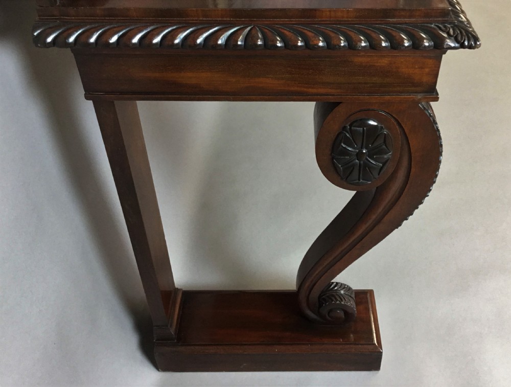 A Regency period dark mahogany serving table featuring carved scroll legs with acanthus leaves, a gadrooned top edge, and a raised carved backrail. View VIII
