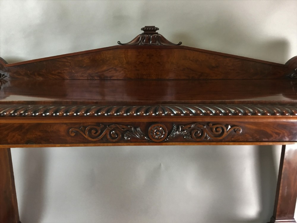 A Regency period dark mahogany serving table featuring carved scroll legs with acanthus leaves, a gadrooned top edge, and a raised carved backrail. View X