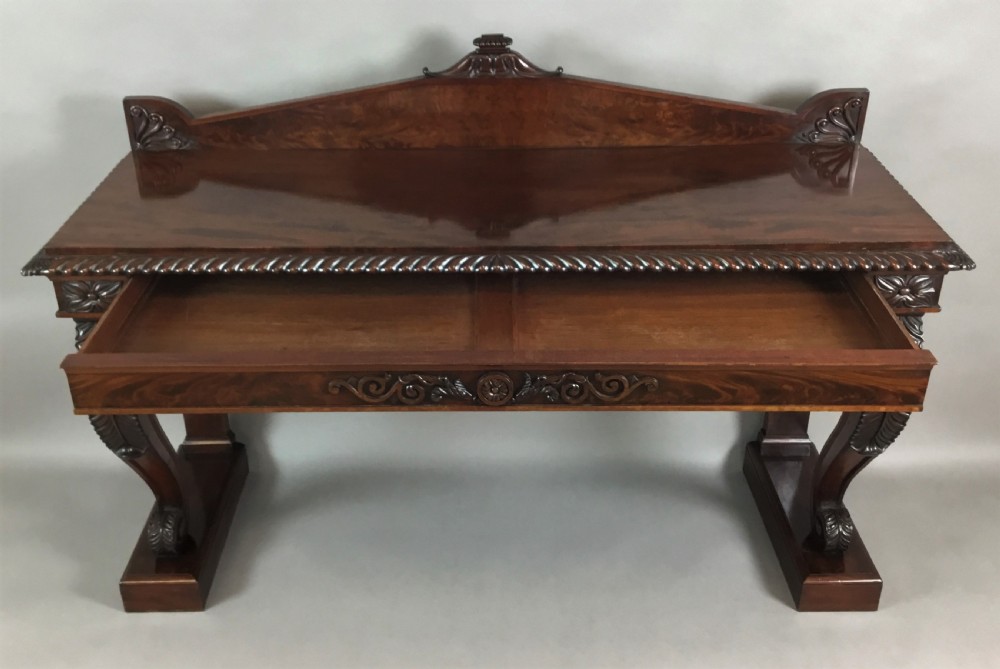 A Regency period dark mahogany serving table featuring carved scroll legs with acanthus leaves, a gadrooned top edge, and a raised carved backrail. View XI