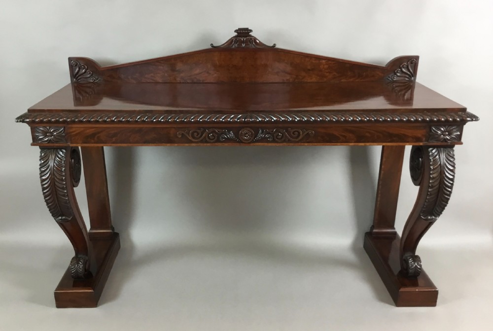 A Regency period dark mahogany serving table featuring carved scroll legs with acanthus leaves, a gadrooned top edge, and a raised carved backrail. View XIII