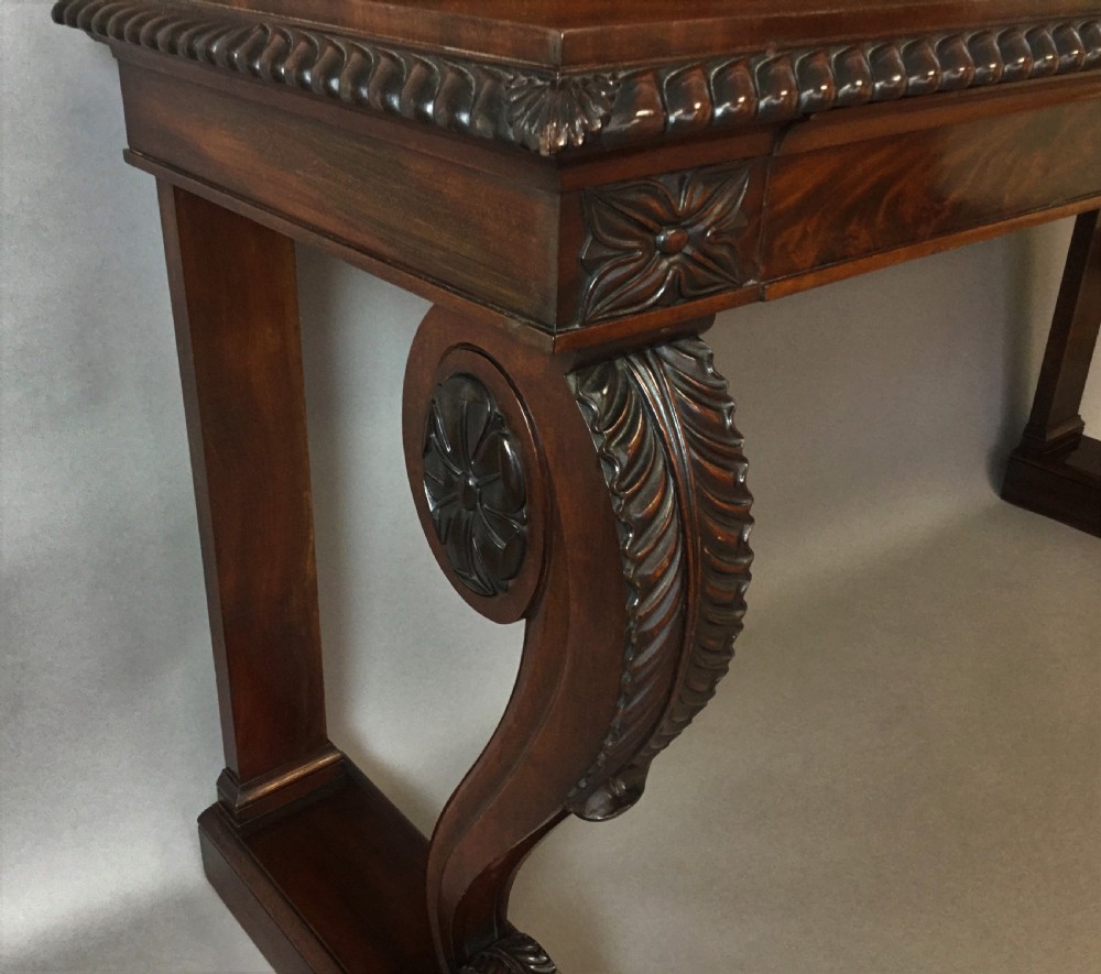 A Regency period dark mahogany serving table featuring carved scroll legs with acanthus leaves, a gadrooned top edge, and a raised carved backrail. View XV