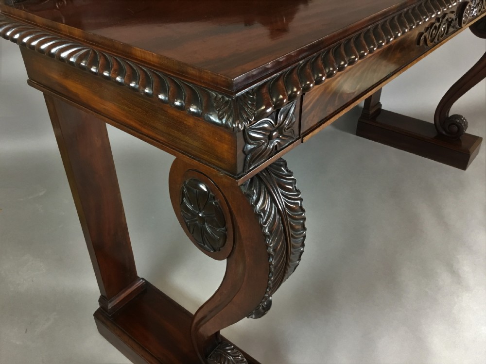 A Regency period dark mahogany serving table featuring carved scroll legs with acanthus leaves, a gadrooned top edge, and a raised carved backrail. View XXI