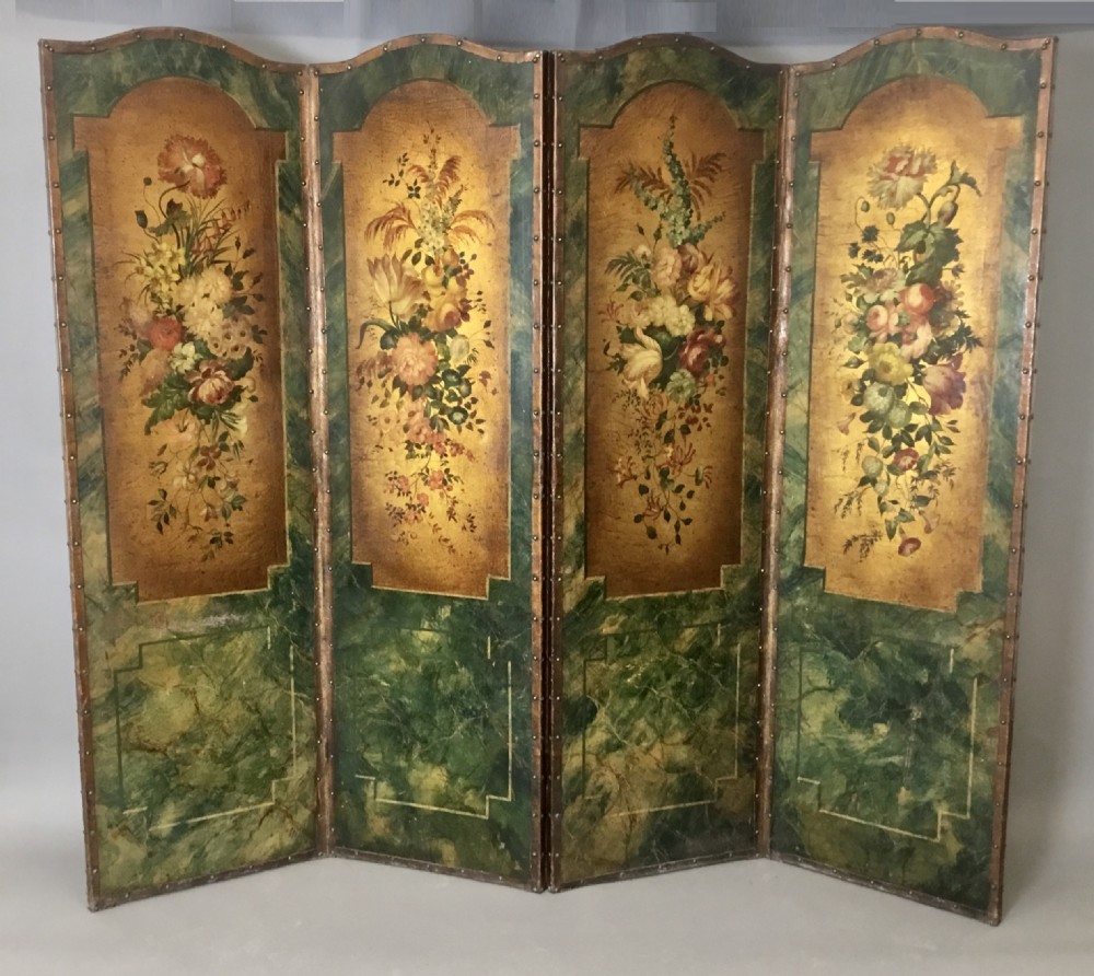A 19th-century four-fold leather room divider screen featuring painted floral panels framed in faux-marble green borders with brass stud detailing.