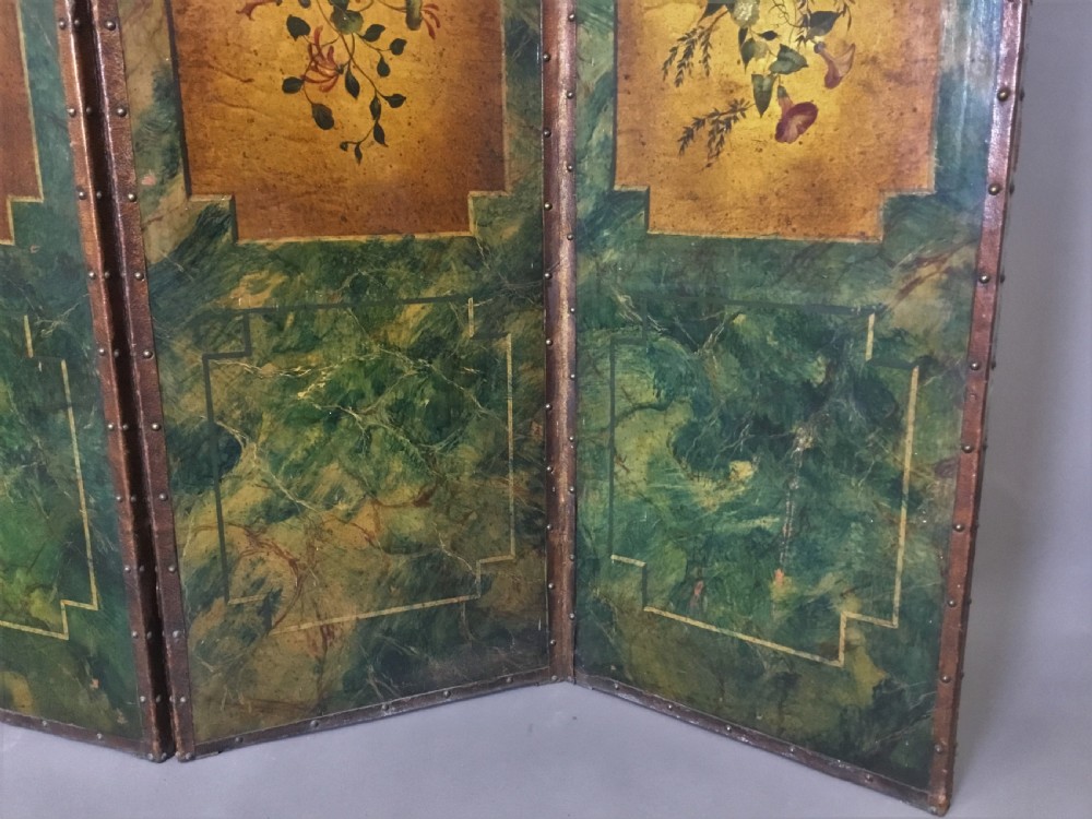 A 19th-century four-fold leather room divider screen featuring painted floral panels framed in faux-marble green borders with brass stud detailing. View IV