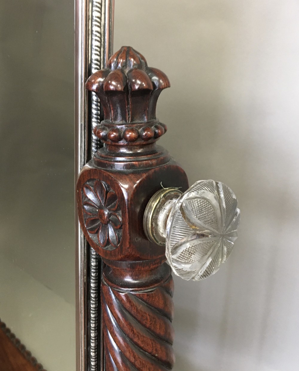 An antique Regency Anglo-Indian dark padouk timber dressing mirror featuring spiral twist columns, carved rope-twist base trim, glass side knobs, and a tall rectangular mirror plate. View III