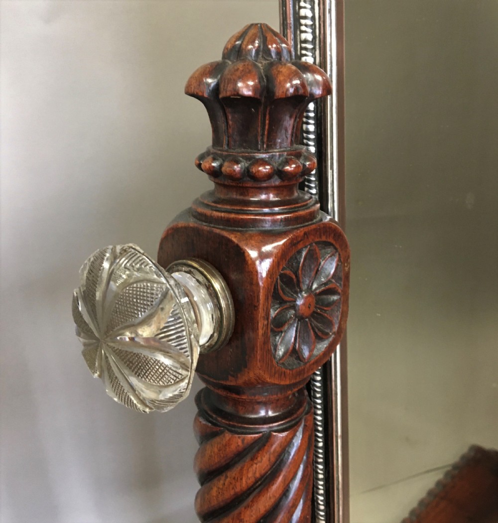 An antique Regency Anglo-Indian dark padouk timber dressing mirror featuring spiral twist columns, carved rope-twist base trim, glass side knobs, and a tall rectangular mirror plate. View V