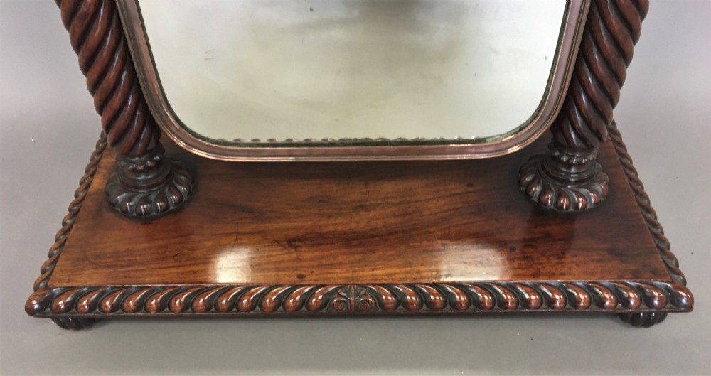An antique Regency Anglo-Indian dark padouk timber dressing mirror featuring spiral twist columns, carved rope-twist base trim, glass side knobs, and a tall rectangular mirror plate. View VIII