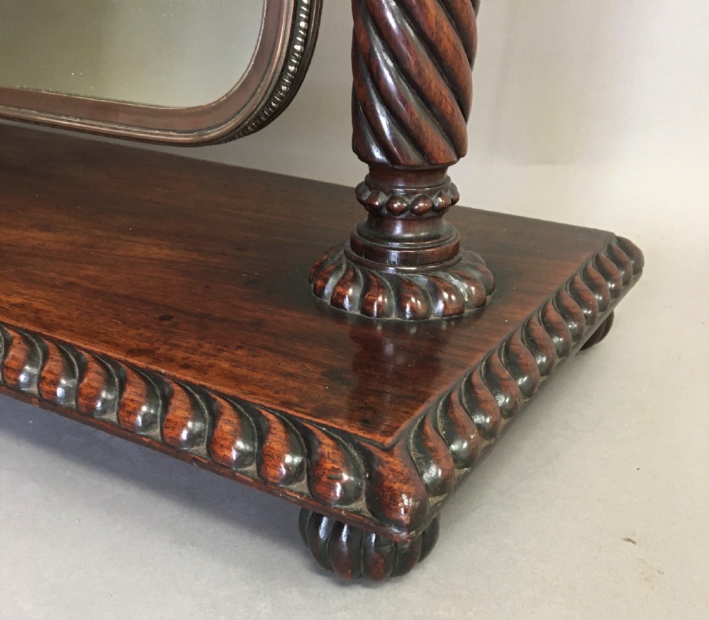 An antique Regency Anglo-Indian dark padouk timber dressing mirror featuring spiral twist columns, carved rope-twist base trim, glass side knobs, and a tall rectangular mirror plate. View XI
