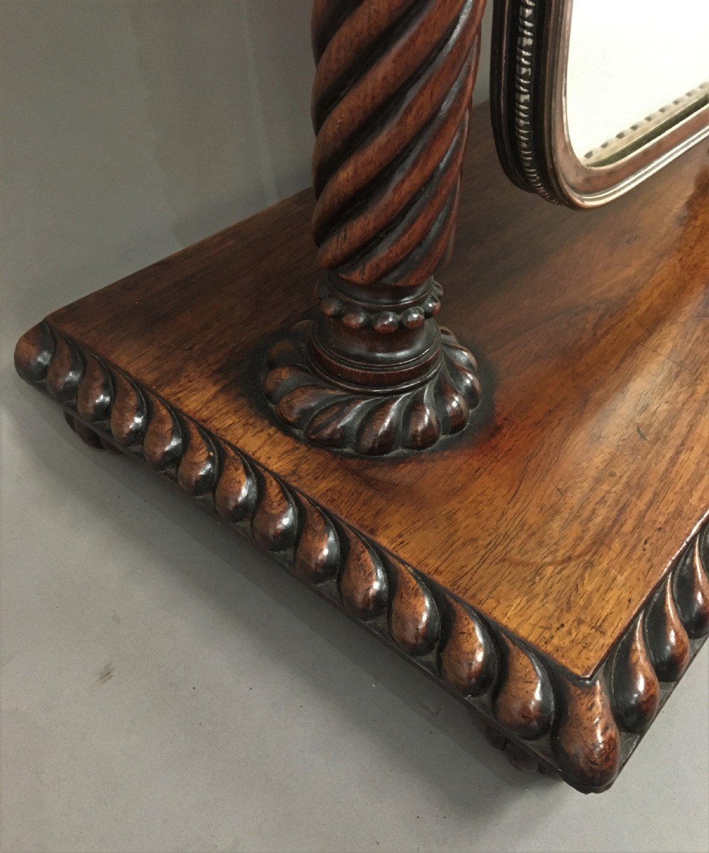 An antique Regency Anglo-Indian dark padouk timber dressing mirror featuring spiral twist columns, carved rope-twist base trim, glass side knobs, and a tall rectangular mirror plate. View XII