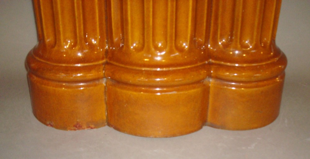 A 19th-century ceramic umbrella stand with an ochre yellow glaze, formed as three connected fluted architectural columns. View VI
