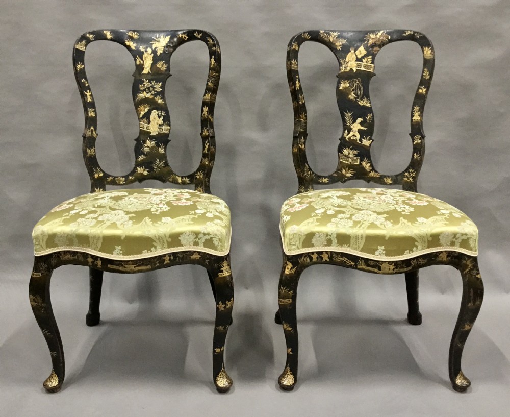 A pair of 18th-century Dutch black lacquered side chairs featuring gold chinoiserie motifs, shaped splat backs, cabriole legs, and green patterned silk seats. View II