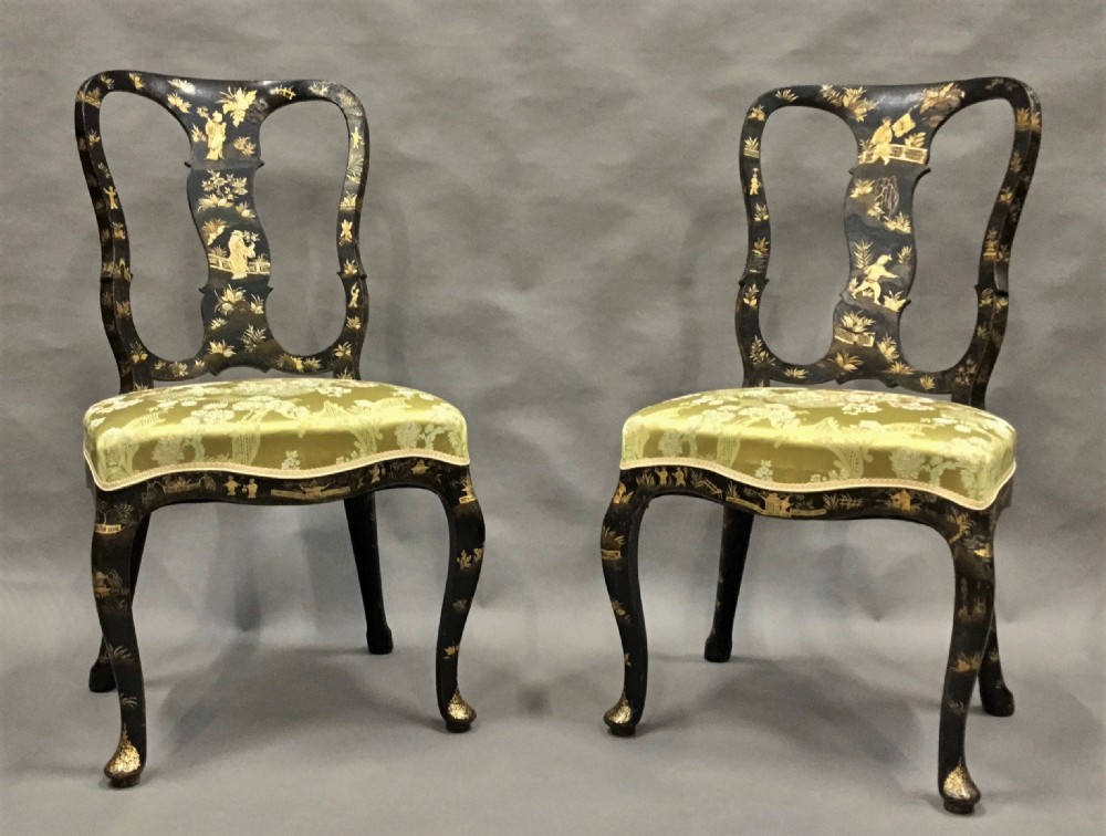A pair of 18th-century Dutch black lacquered side chairs featuring gold chinoiserie motifs, shaped splat backs, cabriole legs, and green patterned silk seats. View V