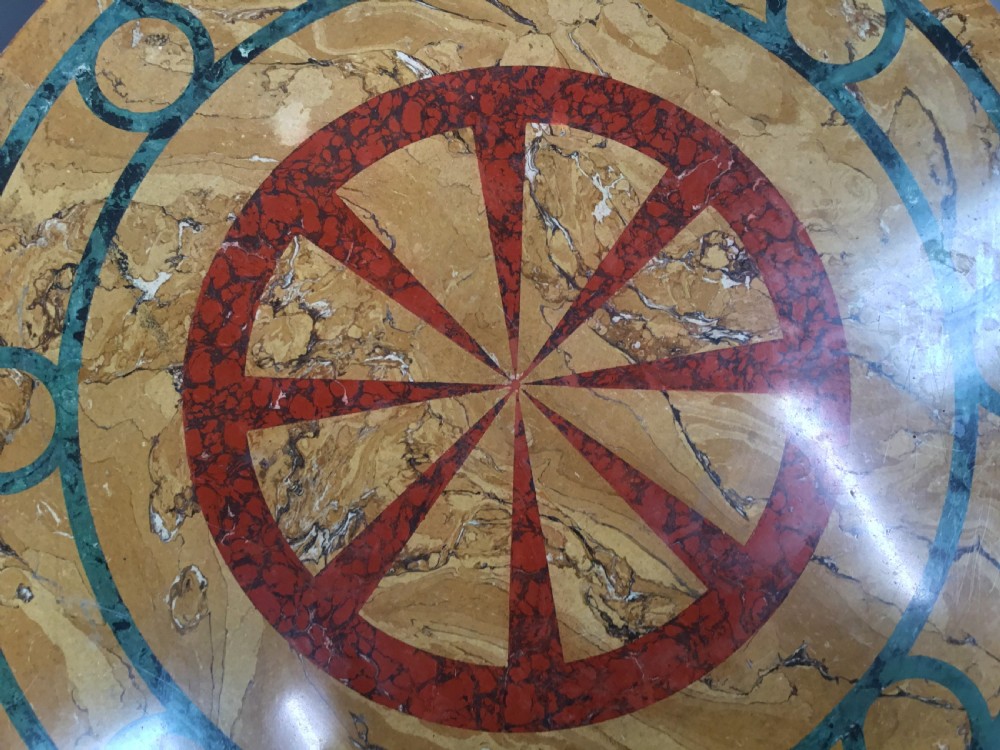 A circular 19th-century Italian scagliola centre table featuring a red wheel motif in the centre, green circular inlay, a cylindrical pedestal, and a tripartite base. View XI