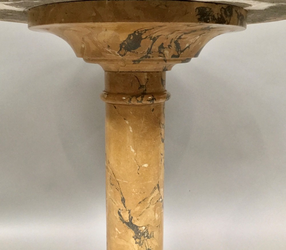 A circular 19th-century Italian scagliola centre table featuring a red wheel motif in the centre, green circular inlay, a cylindrical pedestal, and a tripartite base. View XII