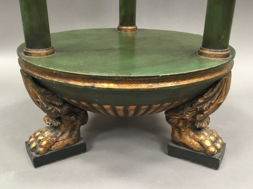 A pair of tall 19th-century Swedish neoclassical stands painted green with gilded accents, circular tops, lower shelves, and turned columns raised on carved lion paw feet. View VII