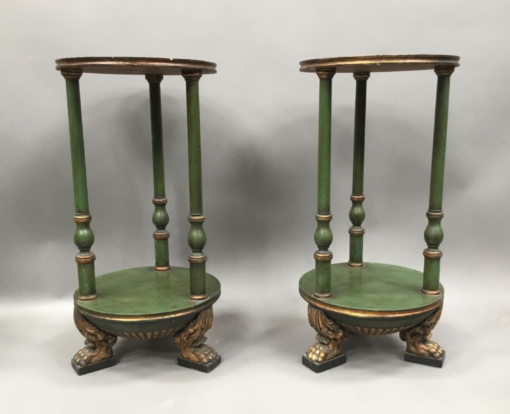 A pair of tall 19th-century Swedish neoclassical stands painted green with gilded accents, circular tops, lower shelves, and turned columns raised on carved lion paw feet. View XVII