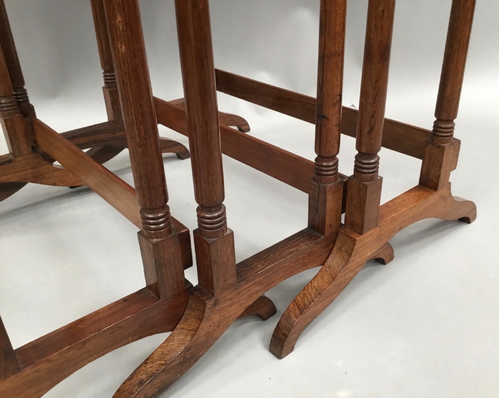 A set of three graduated Regency rosewood nesting tables featuring turned twin-spindle legs and trestle feet. View XI