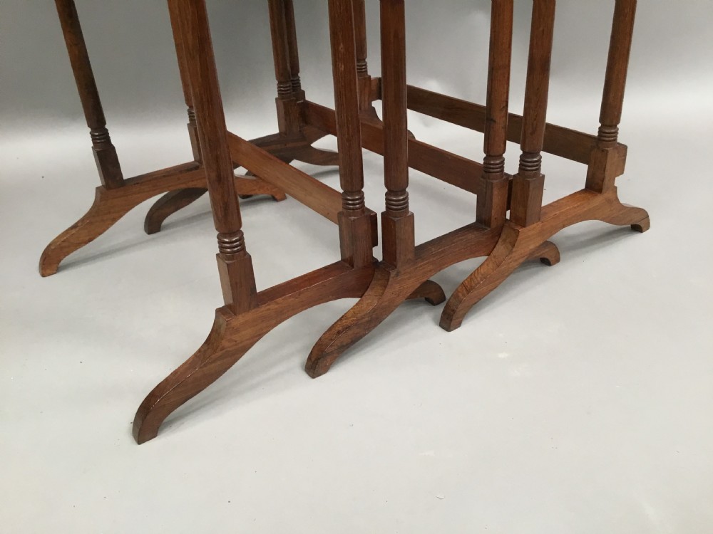 A set of three graduated Regency rosewood nesting tables featuring turned twin-spindle legs and trestle feet. View XIII
