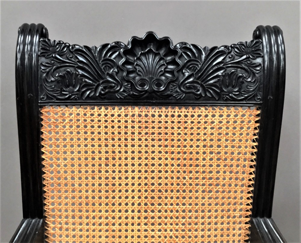 C19th Indian carved ebony open arm library chair; finely carved in solid ebony.  Galle District, Ceylon View IV
