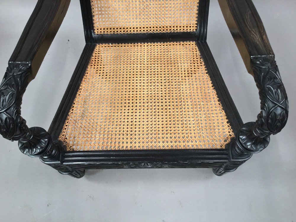 C19th Indian carved ebony open arm library chair; finely carved in solid ebony.  Galle District, Ceylon View XXVI
