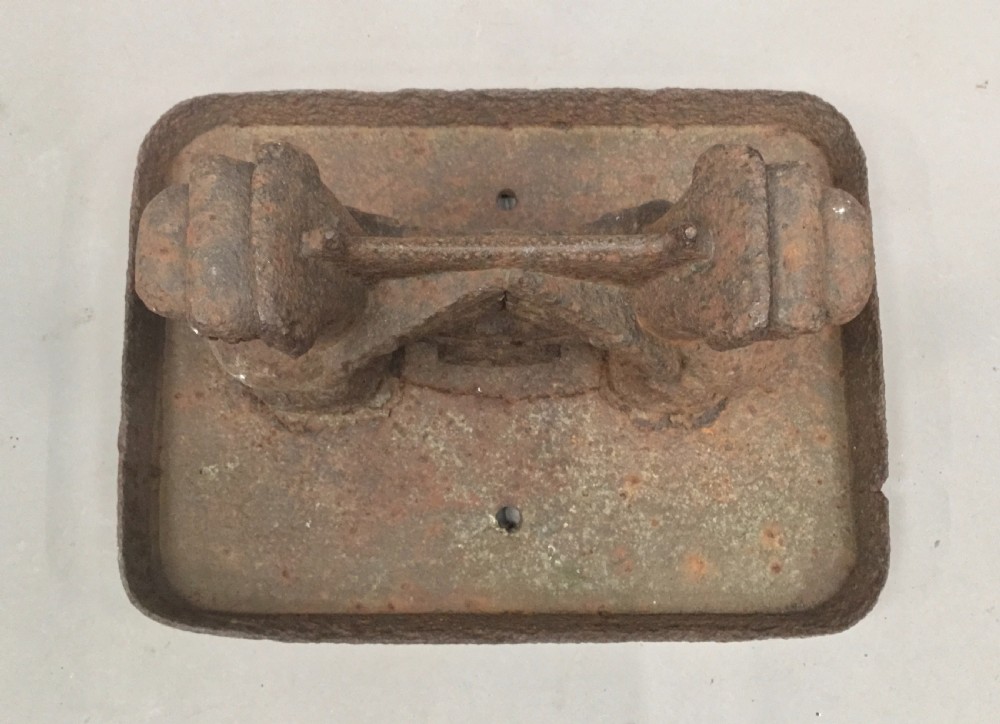 A pair of antique cast iron boot scrapers featuring sculpted griffin side supports and rectangular drip trays with an oxidised surface. View XVI