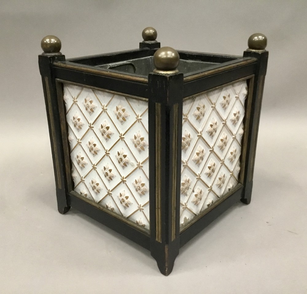 A pair of 19th-century square ebonised wood jardinieres featuring cream ceramic Minton tiles with raised star motifs, brass ball finials, and internal metal liners. View V