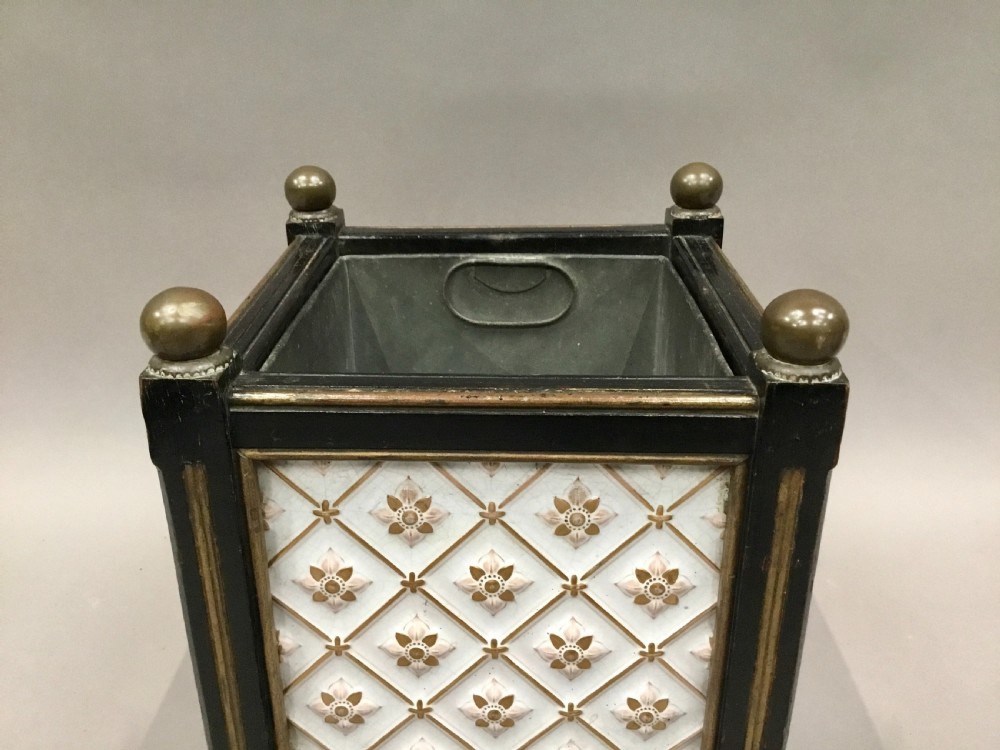 A pair of 19th-century square ebonised wood jardinieres featuring cream ceramic Minton tiles with raised star motifs, brass ball finials, and internal metal liners. View VII