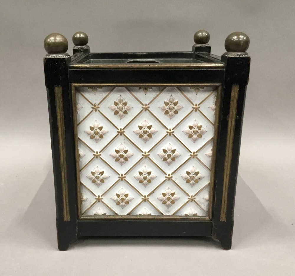 A pair of 19th-century square ebonised wood jardinieres featuring cream ceramic Minton tiles with raised star motifs, brass ball finials, and internal metal liners. View VIII