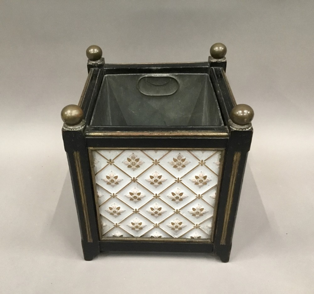 A pair of 19th-century square ebonised wood jardinieres featuring cream ceramic Minton tiles with raised star motifs, brass ball finials, and internal metal liners. View IX