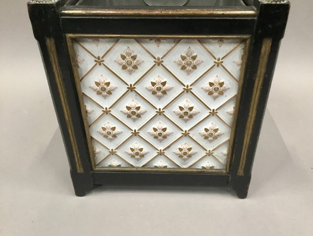 A pair of 19th-century square ebonised wood jardinieres featuring cream ceramic Minton tiles with raised star motifs, brass ball finials, and internal metal liners. View XV