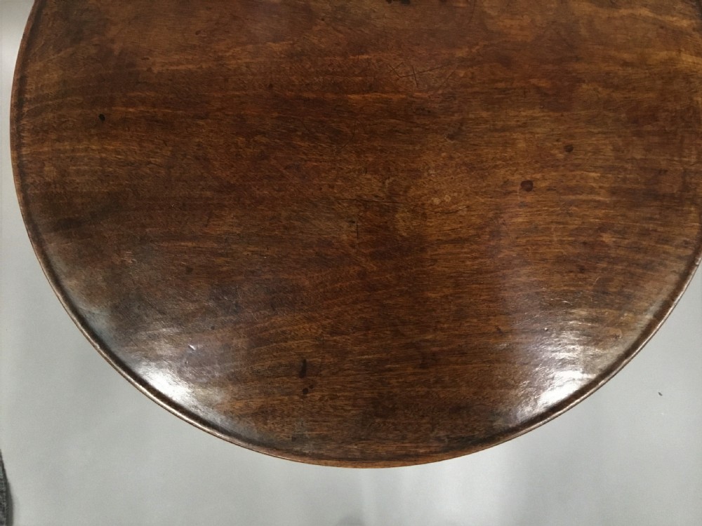 A Georgian dark mahogany tilt-top table featuring a circular top tilted vertically on a turned stem with three cabriole legs. View XIII
