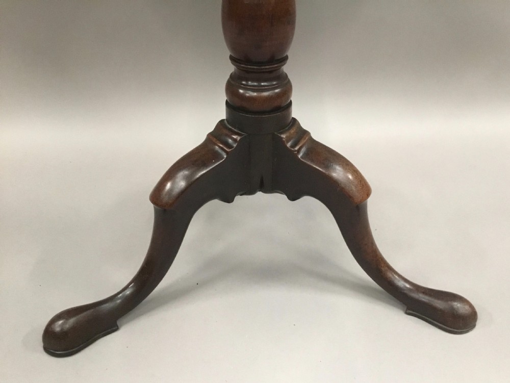 A Georgian dark mahogany tilt-top table featuring a circular top tilted vertically on a turned stem with three cabriole legs. View XVII