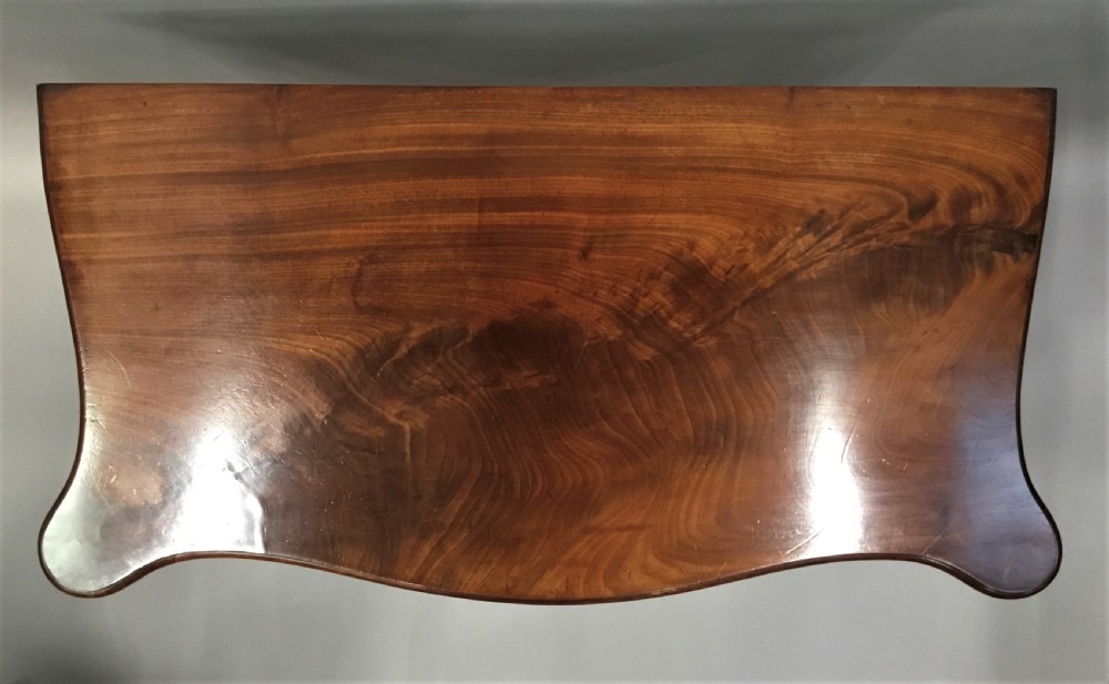 A George III mahogany Hepplewhite card table featuring a serpentine apron, shaped cabriole legs, and a hinged fold-over top. View III