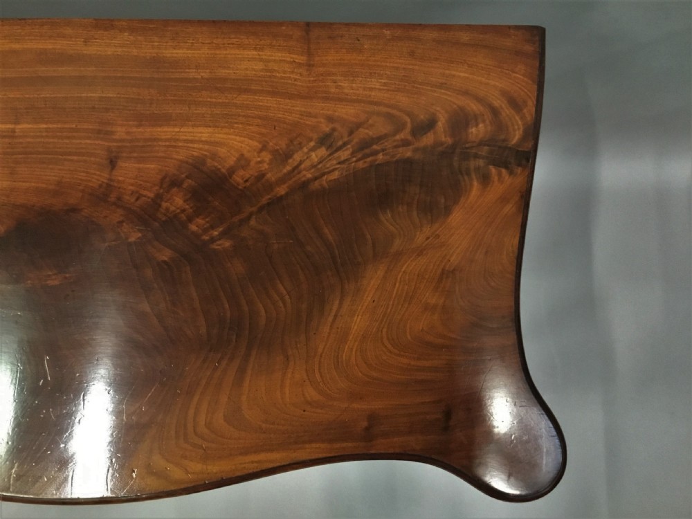 A George III mahogany Hepplewhite card table featuring a serpentine apron, shaped cabriole legs, and a hinged fold-over top. View IX