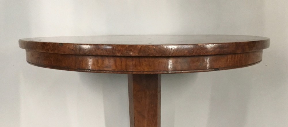 A Regency burr elm occasional table featuring a circular top with detailed grain, supported by an octagonal column and a triform base on bun feet. View XI
