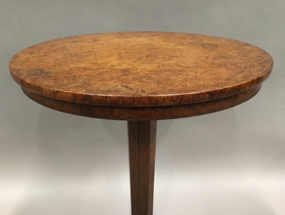 A Regency burr elm occasional table featuring a circular top with detailed grain, supported by an octagonal column and a triform base on bun feet. View XV