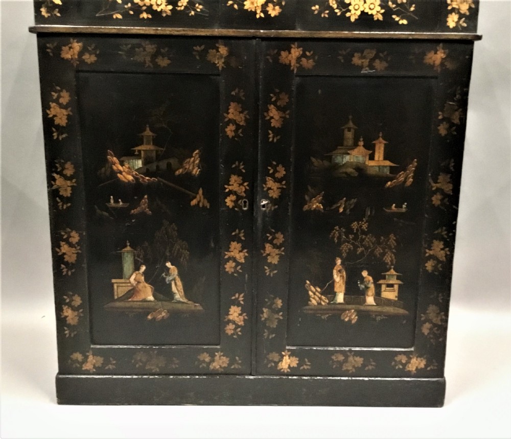 A black lacquered Regency chiffonier side cabinet featuring gold gilded Chinoiserie landscapes, floral borders, a top gallery shelf, and two cupboard doors. View III