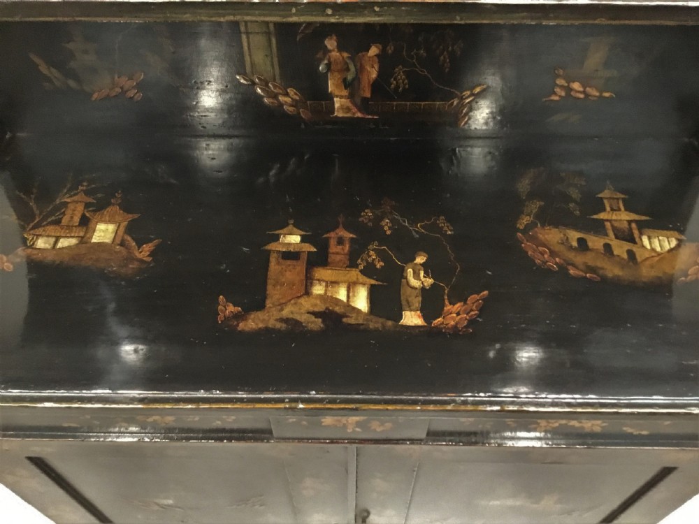 A black lacquered Regency chiffonier side cabinet featuring gold gilded Chinoiserie landscapes, floral borders, a top gallery shelf, and two cupboard doors. View VII