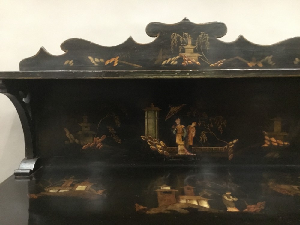 A black lacquered Regency chiffonier side cabinet featuring gold gilded Chinoiserie landscapes, floral borders, a top gallery shelf, and two cupboard doors. View VIII