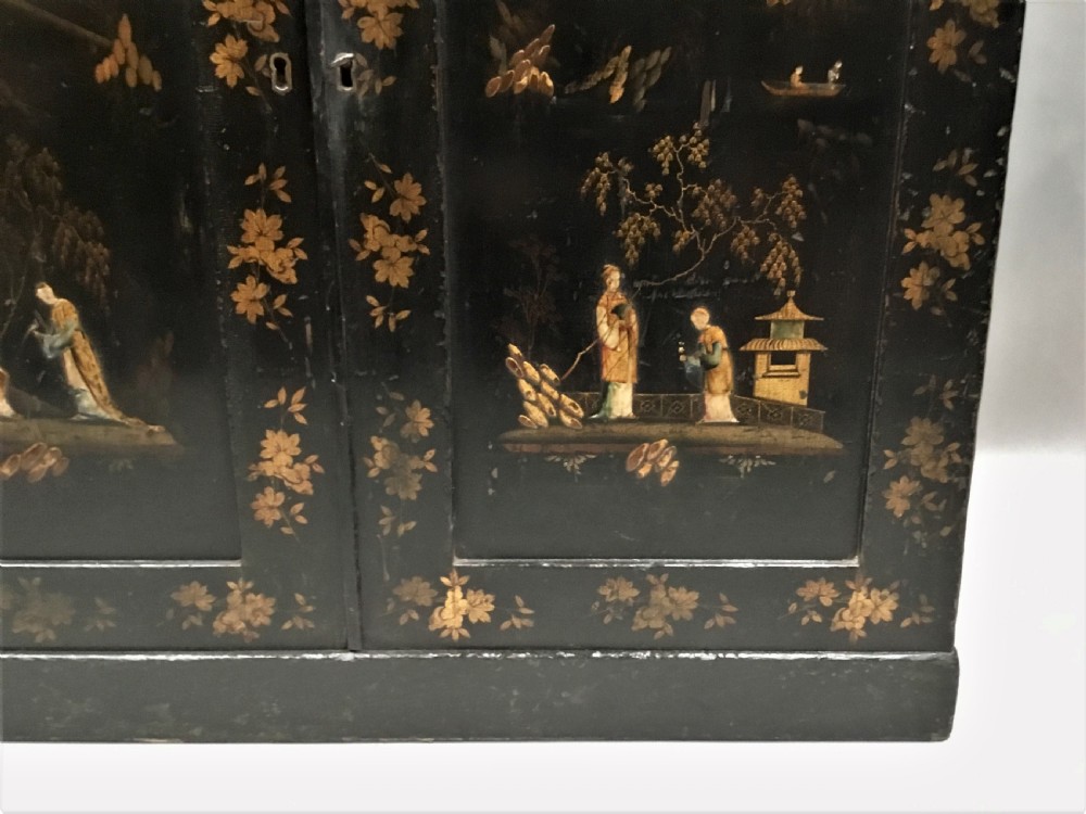 A black lacquered Regency chiffonier side cabinet featuring gold gilded Chinoiserie landscapes, floral borders, a top gallery shelf, and two cupboard doors. View XI