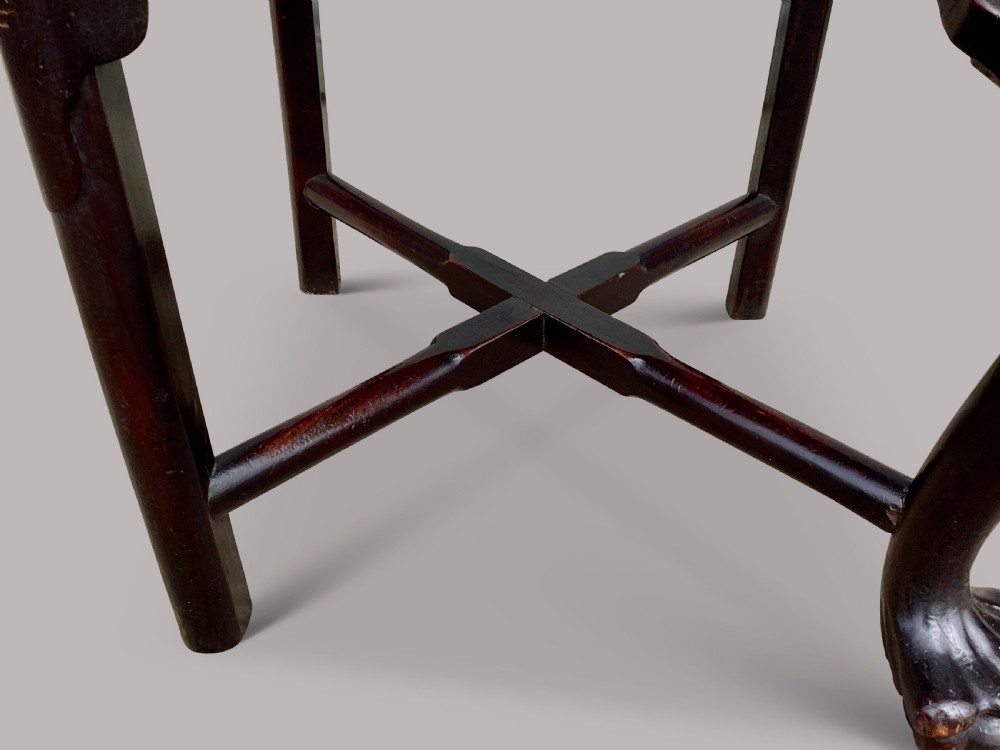 An 18th-century Chinese export dark hardwood corner armchair featuring a curved crest rail, carved splats, an olive green velvet seat, and a cabriole front leg with a carved mask and claw foot. View XXII