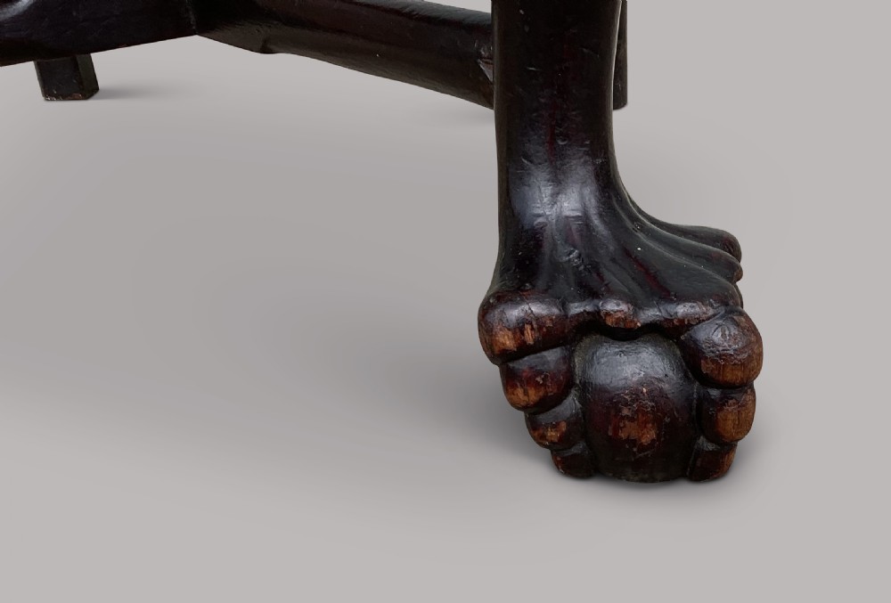 An 18th-century Chinese export dark hardwood corner armchair featuring a curved crest rail, carved splats, an olive green velvet seat, and a cabriole front leg with a carved mask and claw foot. View XXV